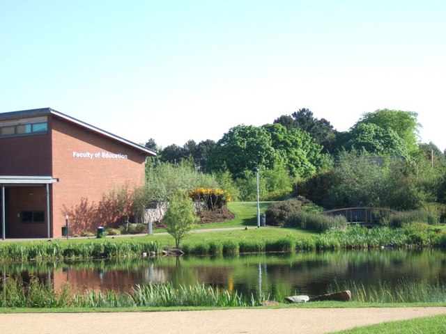 Edge Hill University campus building reflected in the lake